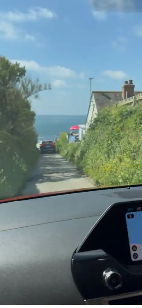 View from a car of a narrow English road.