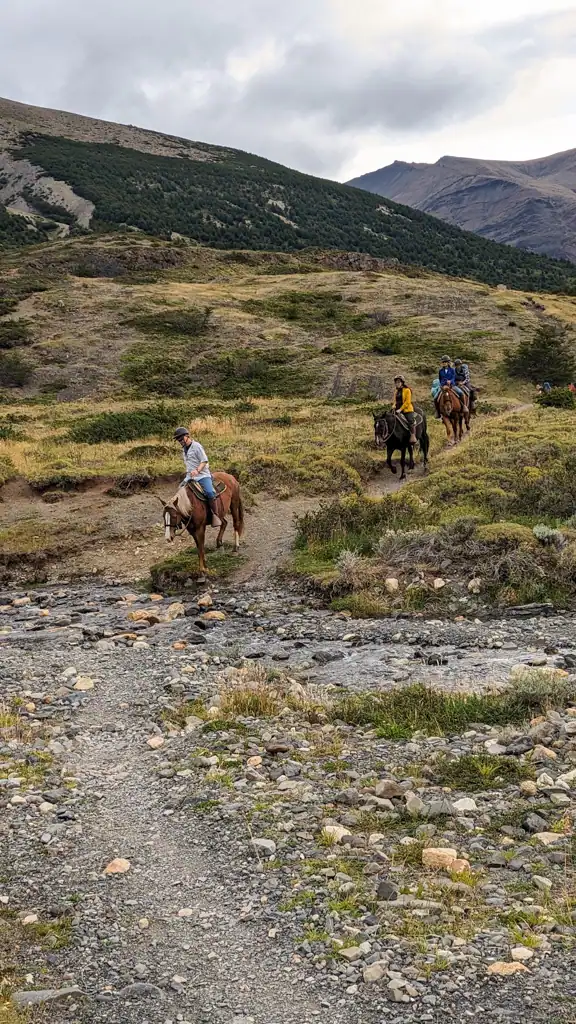 horses and people crossing a stream in Patagonia. 