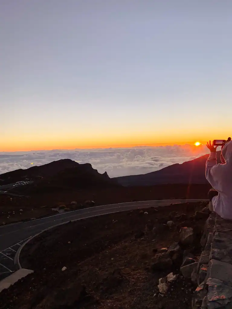 Sunrise at Haleakala National Park with the windy road in the forefront. 