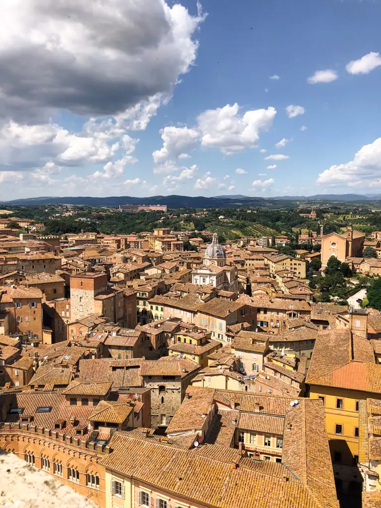 Overlooking the roofs and city of Siena in Tuscany in one of the 5 towns to visit in tuscany
