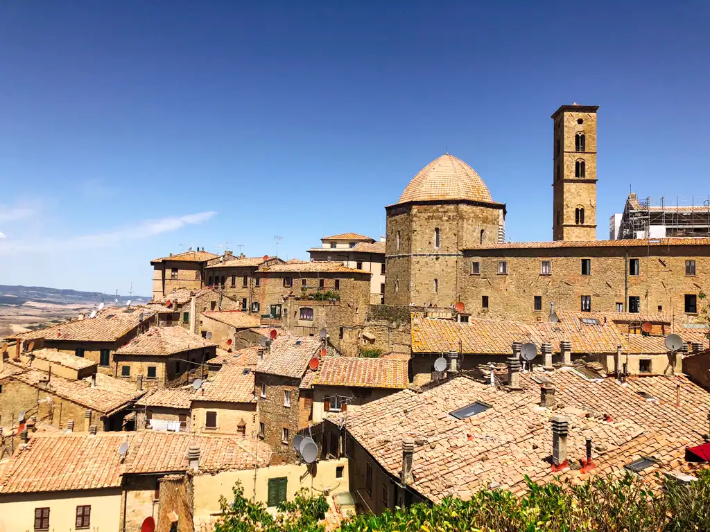 Looking over the town of Volterra in Tuscany with a unique domed tower in one of the 5 towns to visit in tuscany