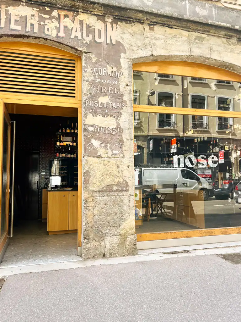 The faded facade of Nose wine bar in Lyon. 