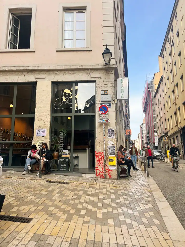 A street corner where people sit. 