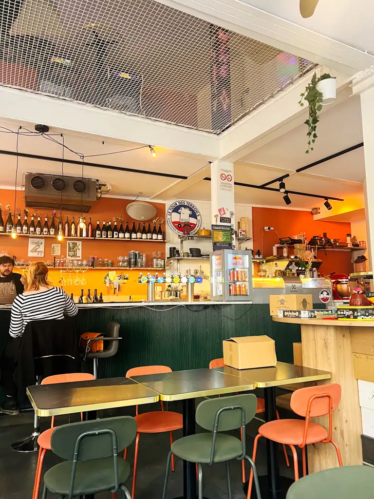 A colorful bar with a netted ceiling. 