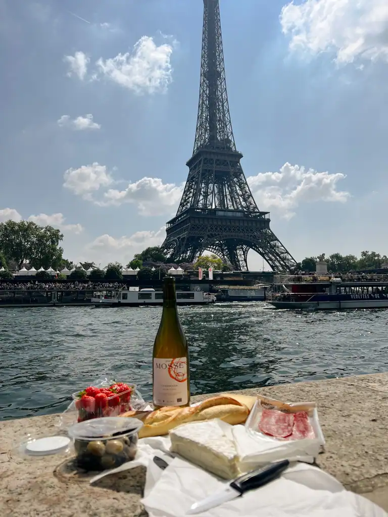 A picture of a french picnic from Port debilly looking at the eiffel tower on a Paris spring day. 
