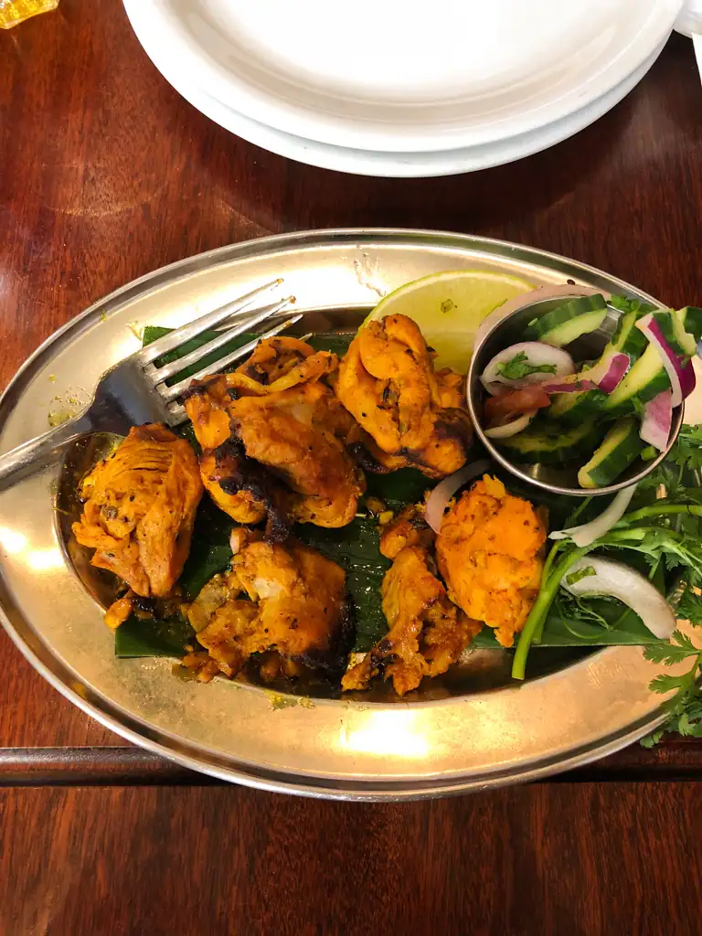 chicken tikka on a silver platter.