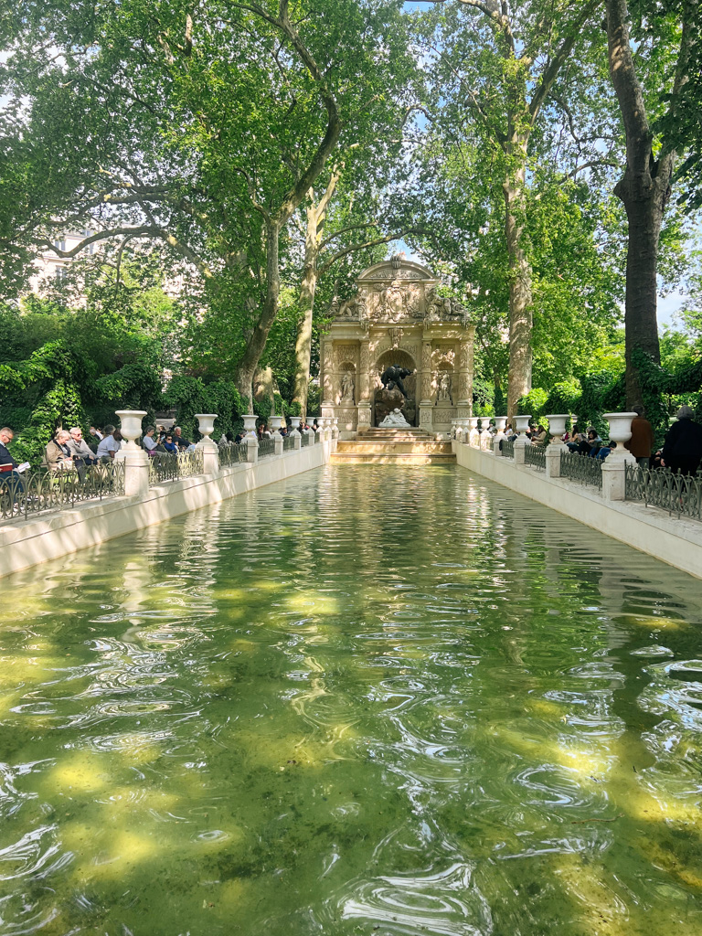 The medici fountain in the Luxembourg park in Paris .