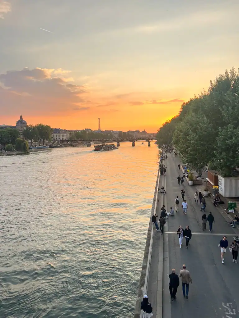 Sunset on a bridge in Paris overlooking the Seine. 