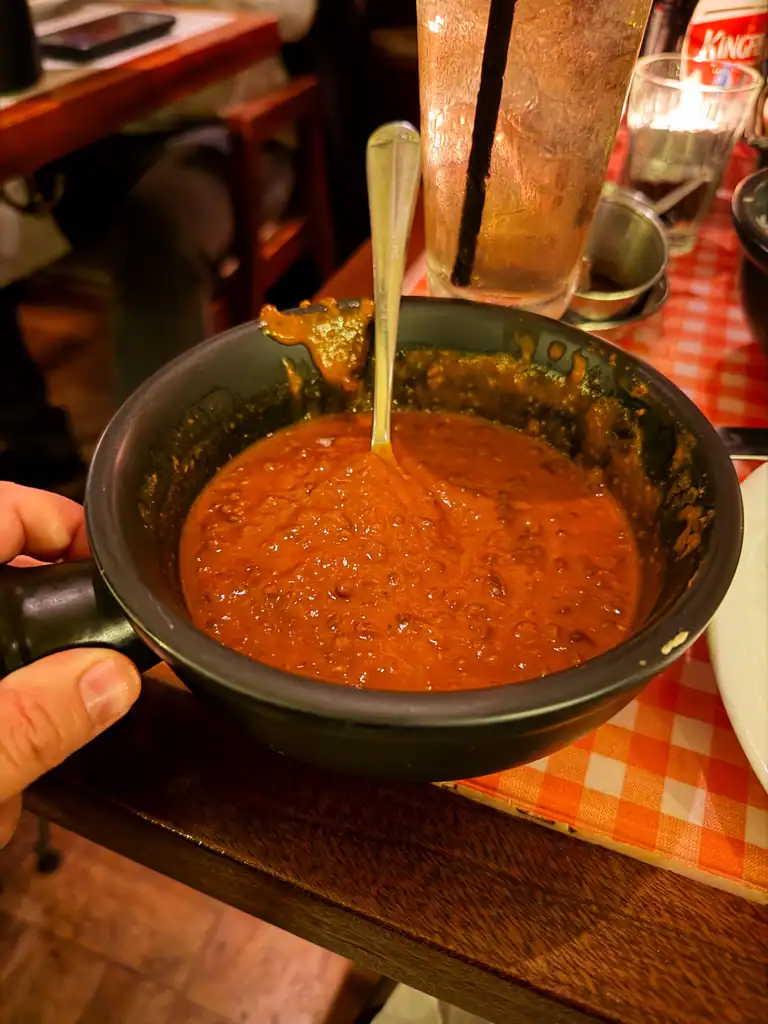 Black daal in a black pot.