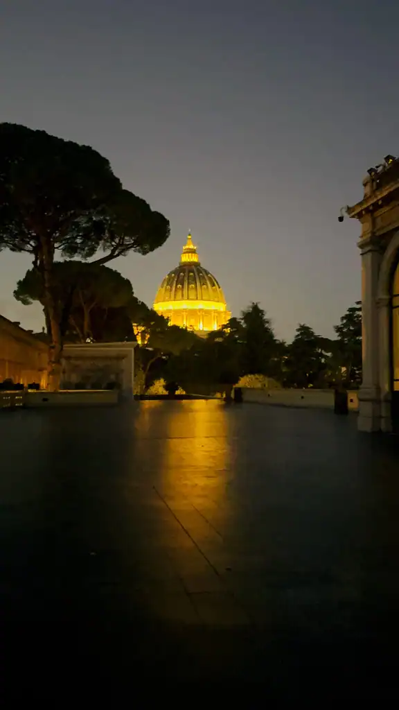 St. Peter's Basilica from a distance before sunrise, it is lit up. 
