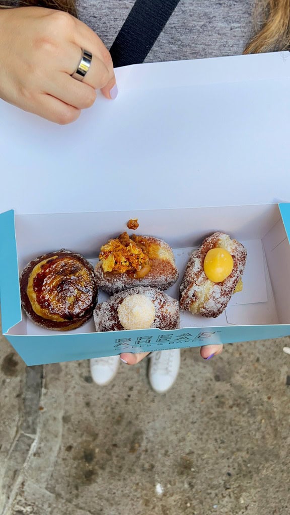 A close up of a box of 4 fancy donuts from Borough Market. 