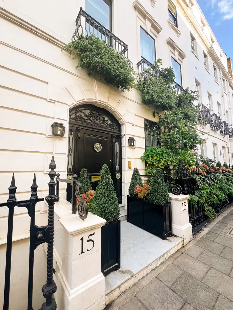 A pretty white house with a black door in london.