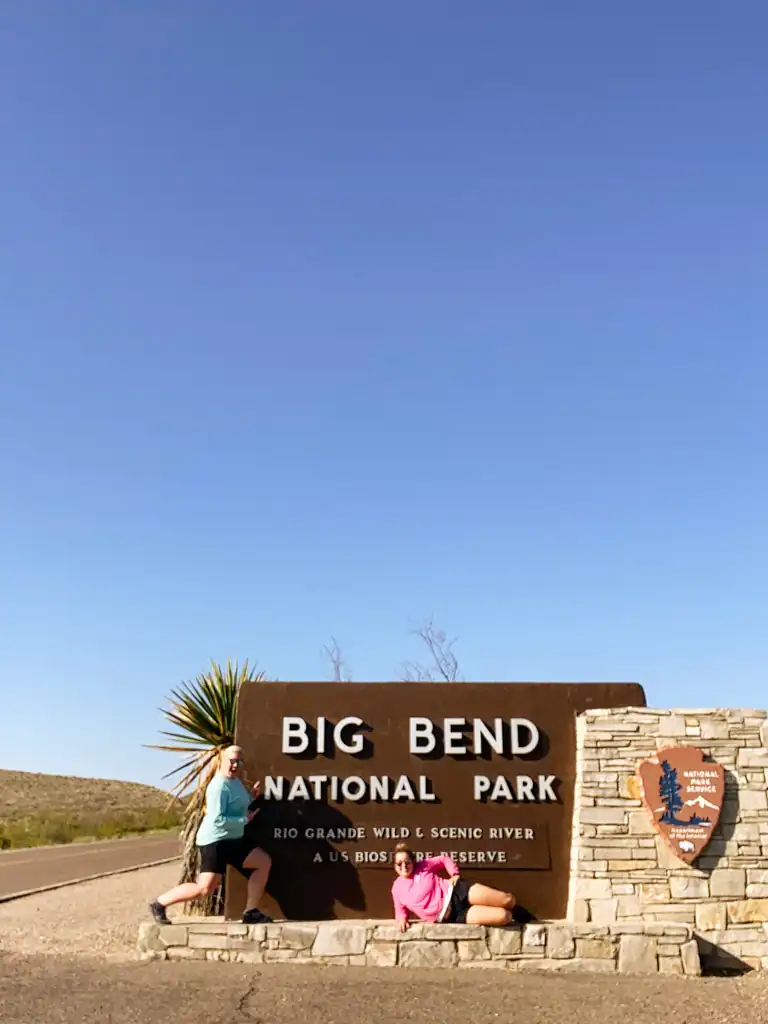 Big Bend National Park entrance sign with two girls. 