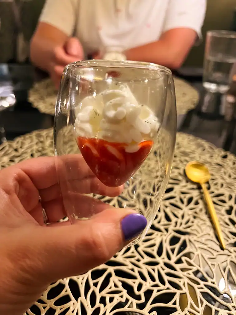 A small red coulis with whipped cream at Az-Zait. 