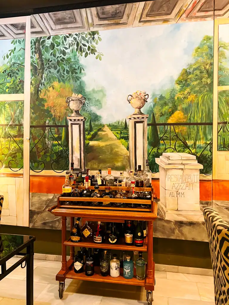 The bar cart at Az-zait for the Az-zait review. The faux terrance painting on the wall. 