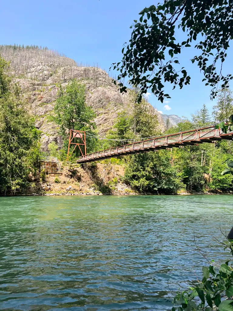 A large, metal bridge crossing over a blue river.