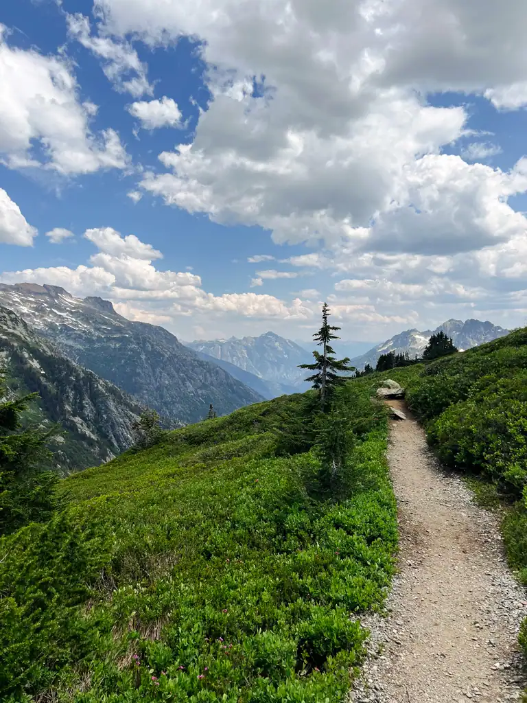 A mountain pass with a rocks, a blue sky with lots of clouds.