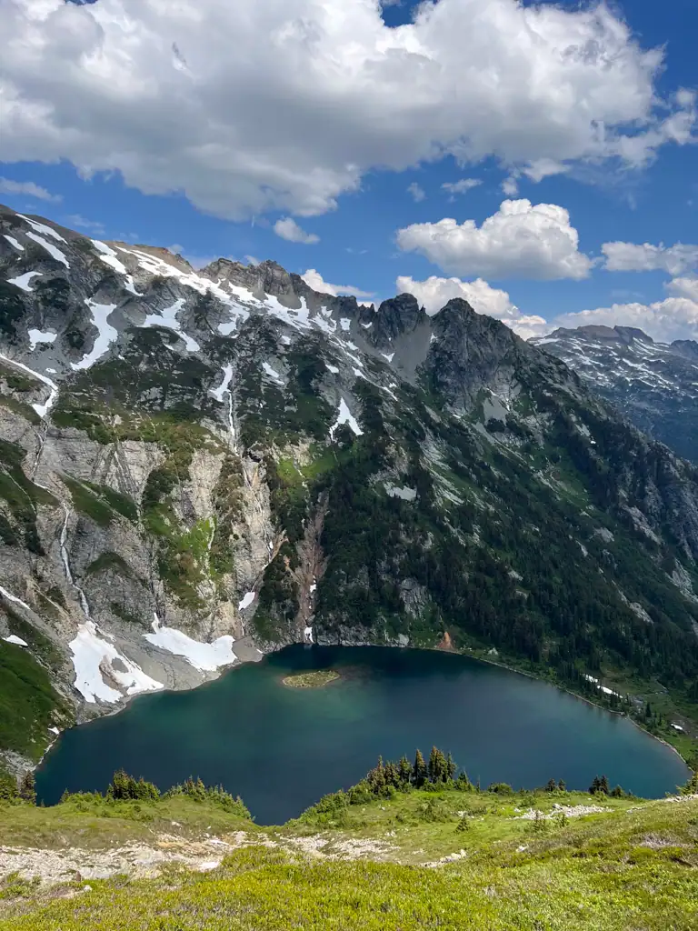 A mountain lake that is dark blue surrounded by mountains.