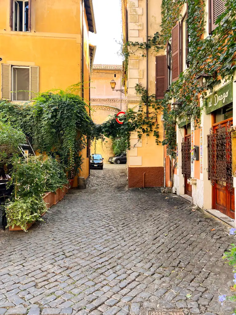 A cobblestoned street in Trastevere, one of the best neighborhoods to stay in Rome. 