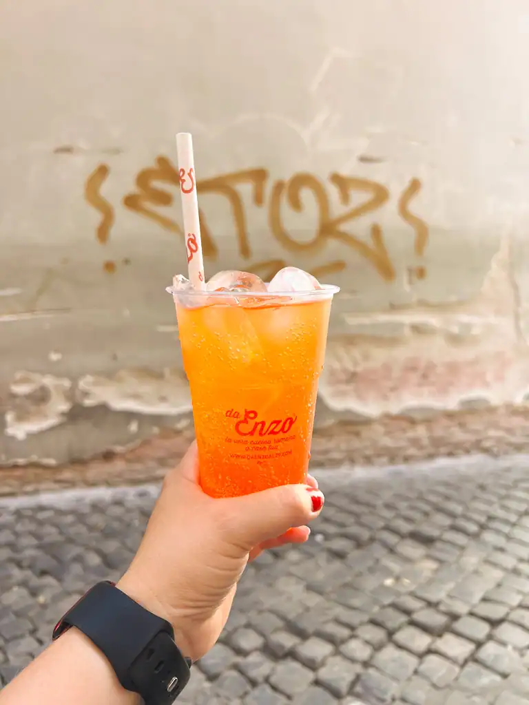 A to go aperol spritz from Enzo restaurant in Trastevere one of the best neighborhoods to stay in Rome. 