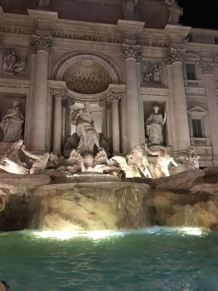 the trevi fountain at night. 