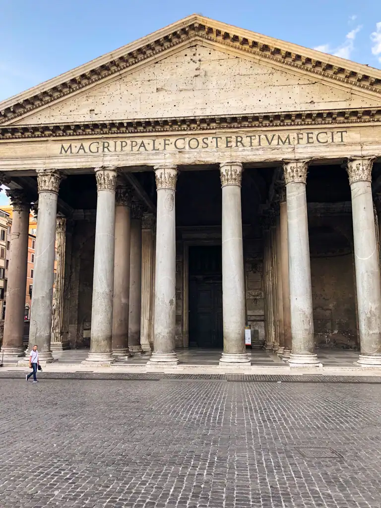 The pantheon in the historic center of Rome with latin words on the facade and Roman columns. 