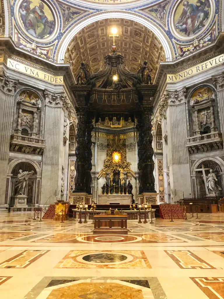 inside st. peters basilica, with grand walls, frescos and an alter. 