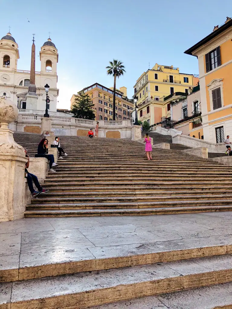 The Spanish Steps in Rome with a palm tree in the background. 