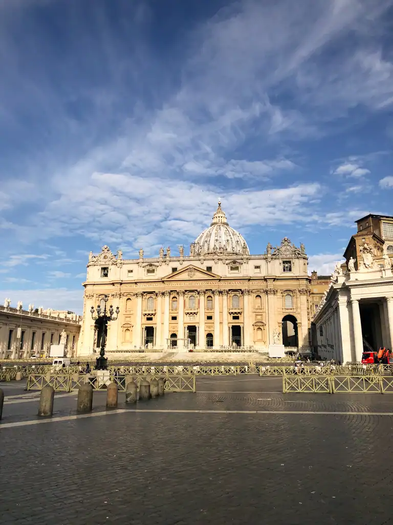St. Peter's Basilica from afar with blue skies and the famous dome in the background. 