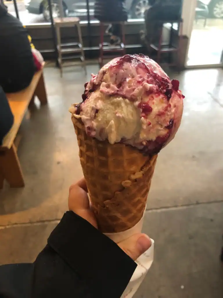 A waffle cone with berry ice cream at Salt and Straw one of the best things to do in portland. 