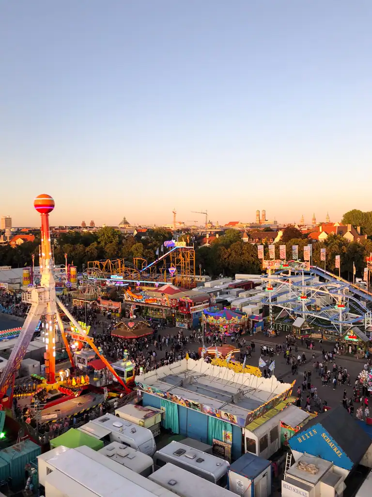 A golden hour view of the rides and tents at Oktoberfest via my essential oktoberfest guide. 
