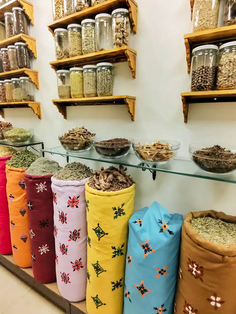 colorful sacks of spices and jars on the shelves of different ingredients. 