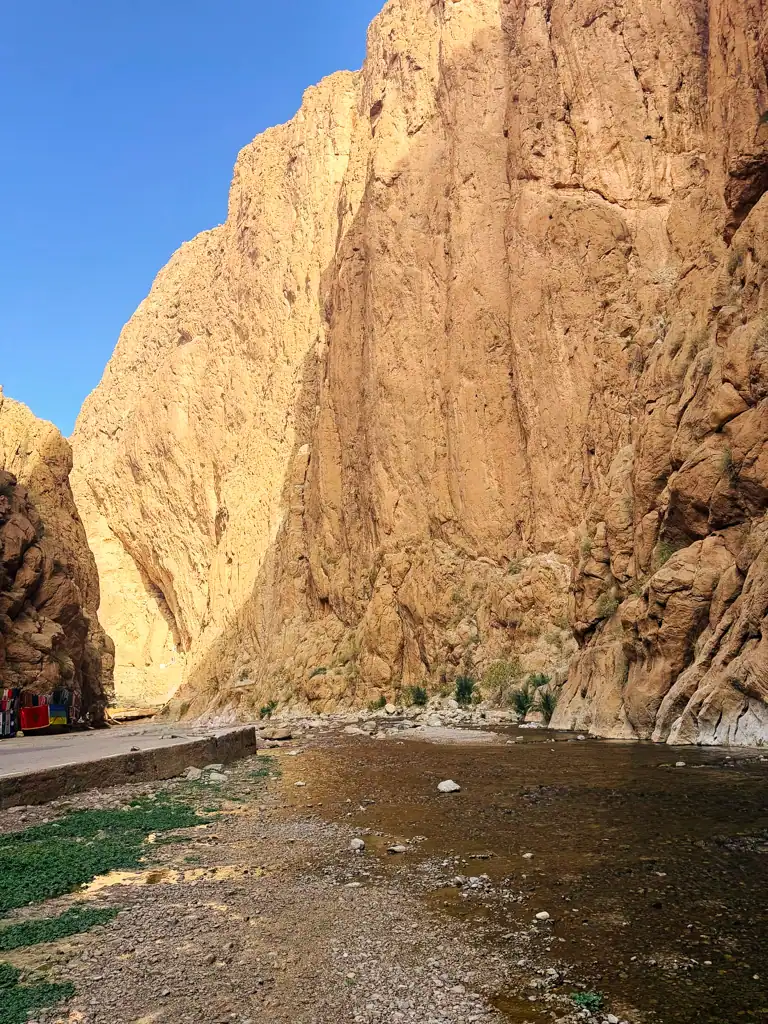 a large gorge with a shallow river running through it.
