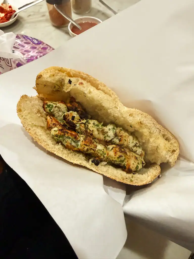 a pita with spiced chicken brochettes inside.