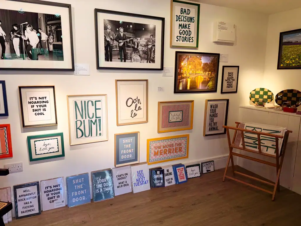 A wall of framed sayings at a store in the cotswolds. 