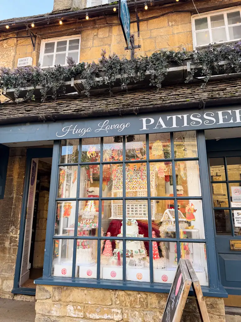 a blue paned window of patisserie in the cotswolds. 