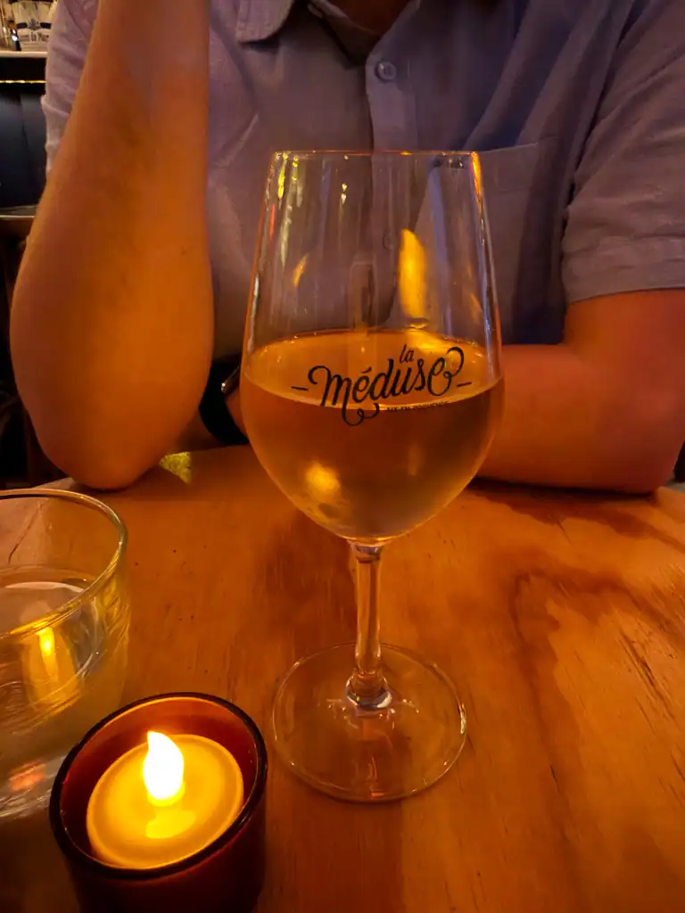 a glass of wine in a glass that says la meduse. 