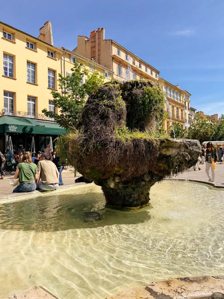 a mossy fountain with clear water in aix-en-provence